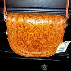 Faux leather cognac tooled cross body bag.